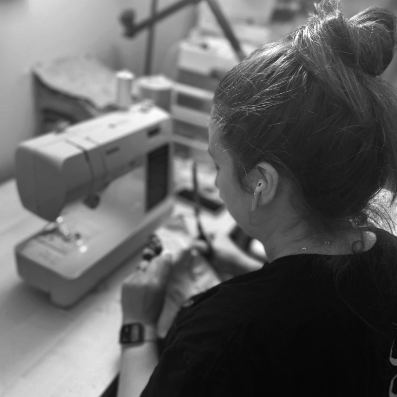 Grace at her desk working on a sewing project